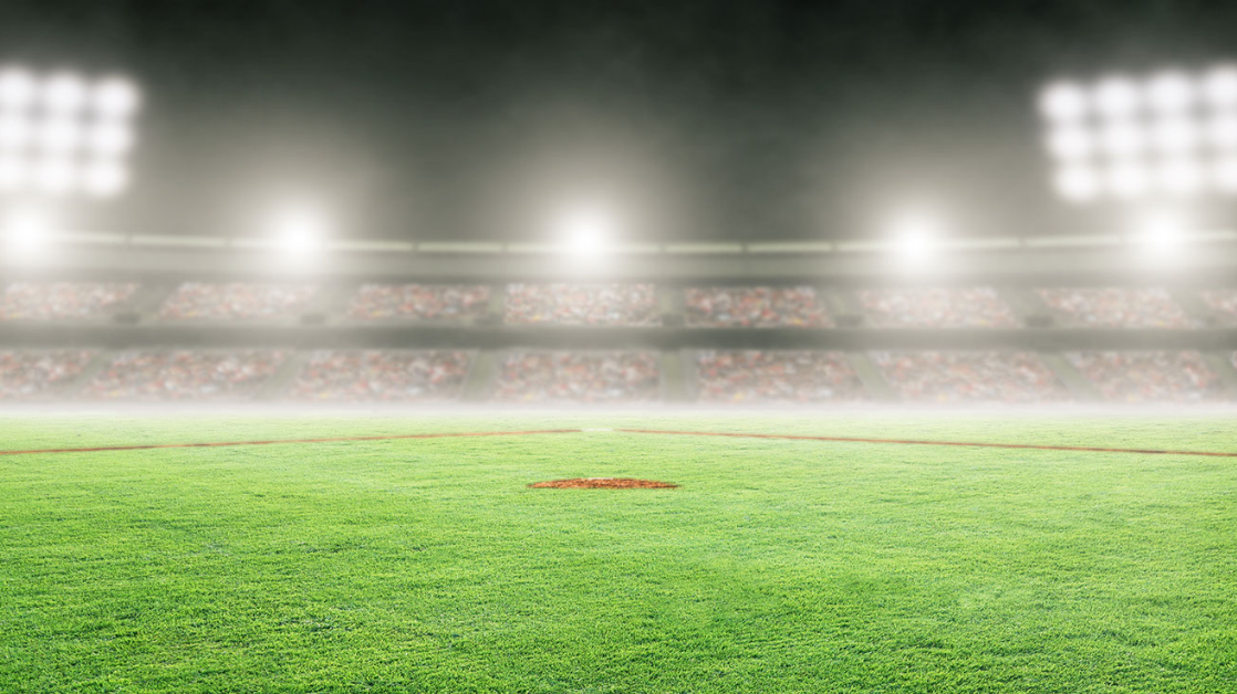 An empty baseball field under the lights