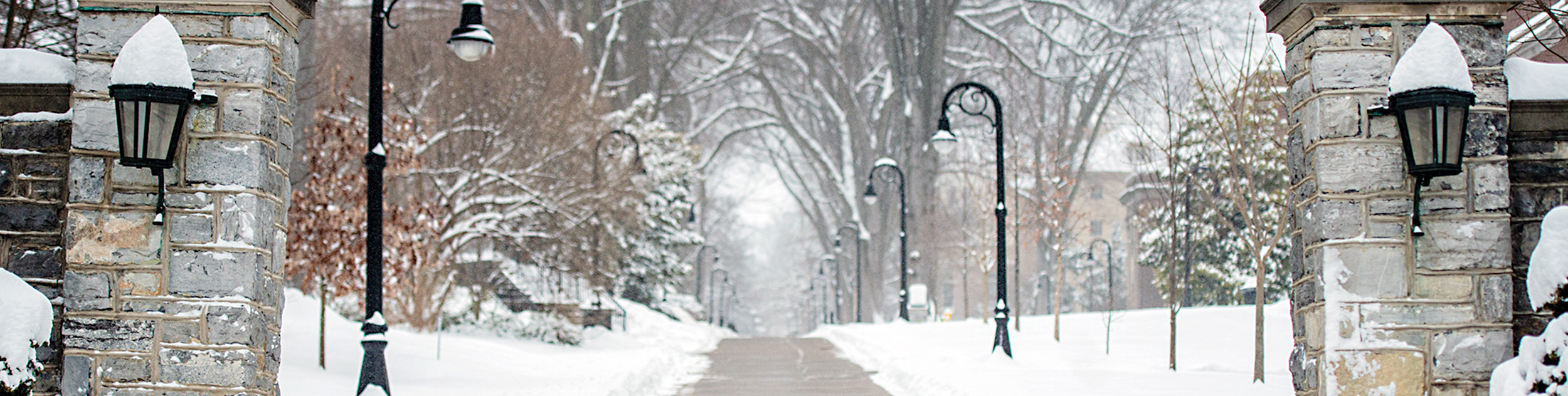 Penn State mall in winter seen through the main gate