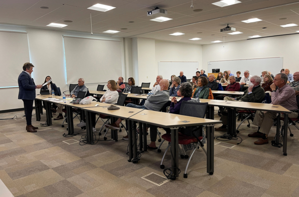 Group of adults in a classroom listening to a lecture