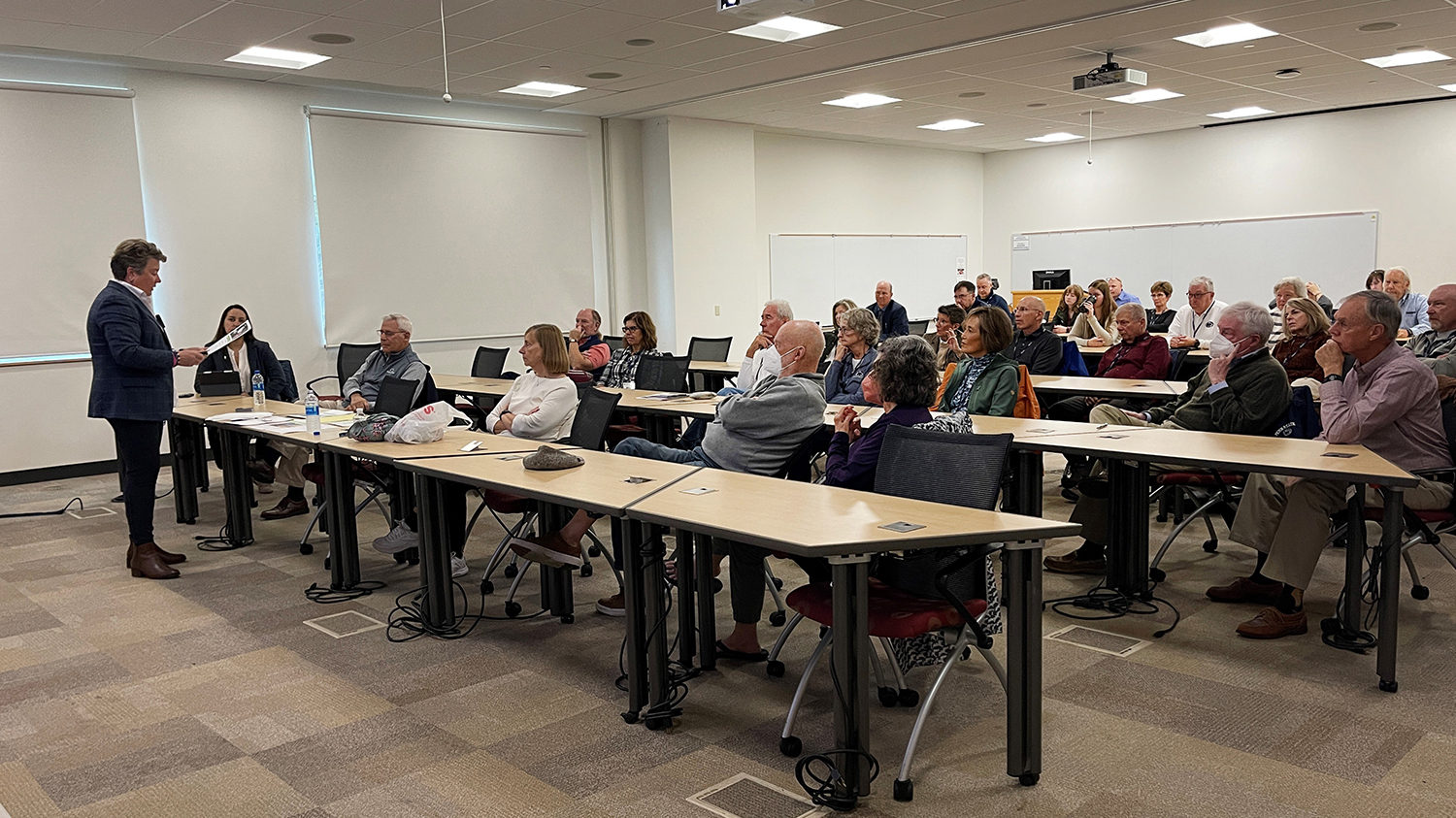 Group of adults in a classroom listening to a lecture