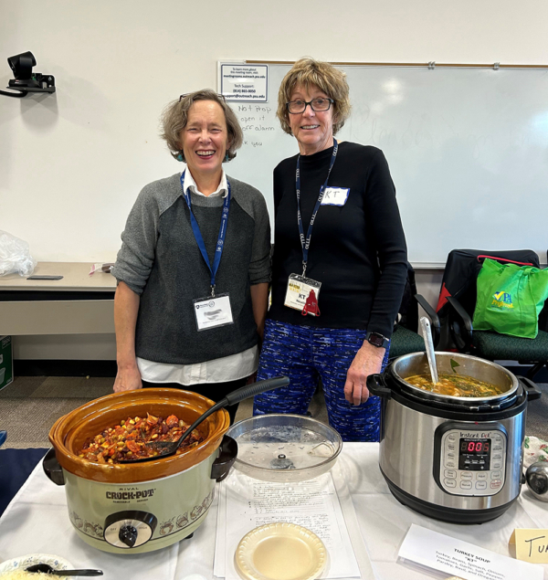 OLLI chefs posing with their slow cookers full of soup.