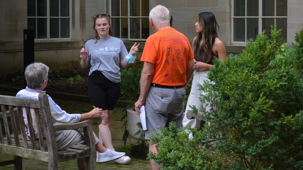 Group of young adults talking with mature adults