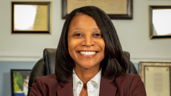 Stacey Waters sitting in chair smiling