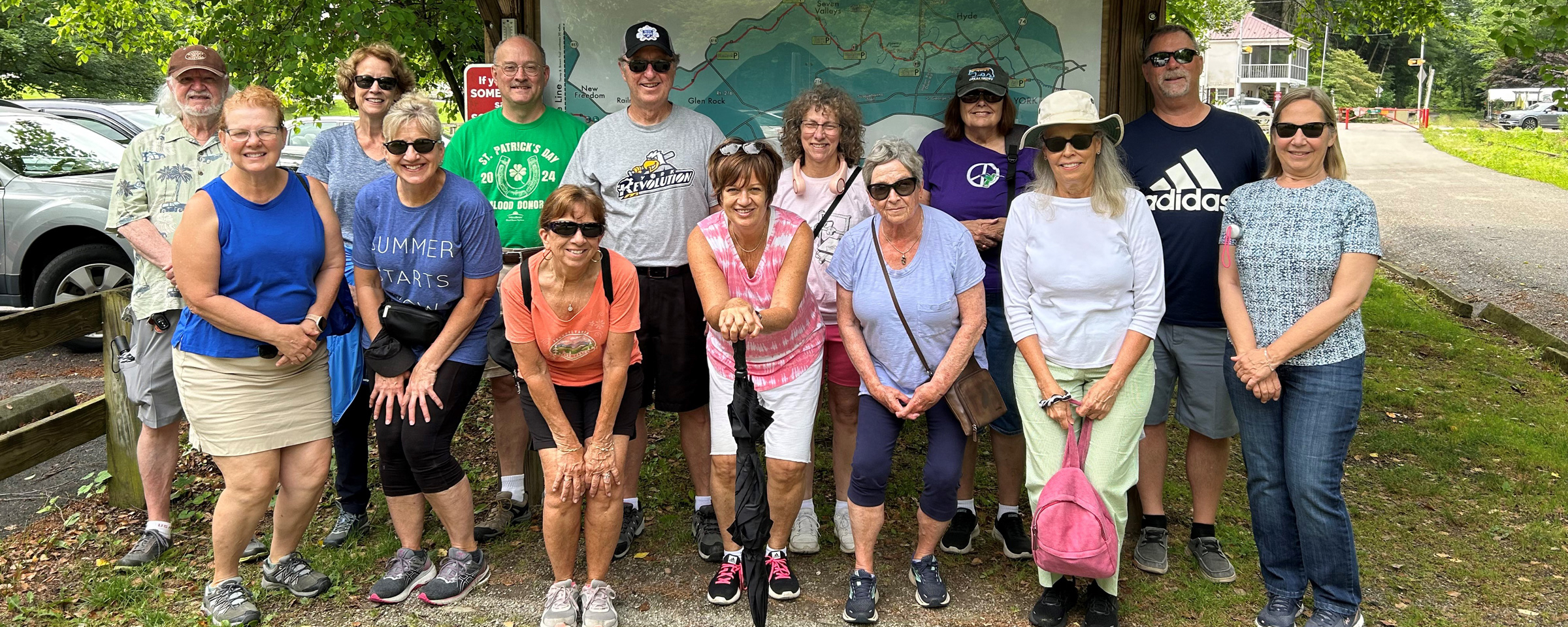 OLLI members in front of a Heritage Rail Trail County Park map sign.