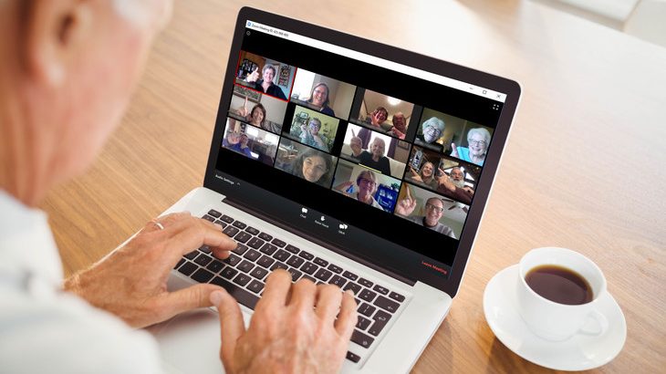 Person on a laptop attending a Zoom conference