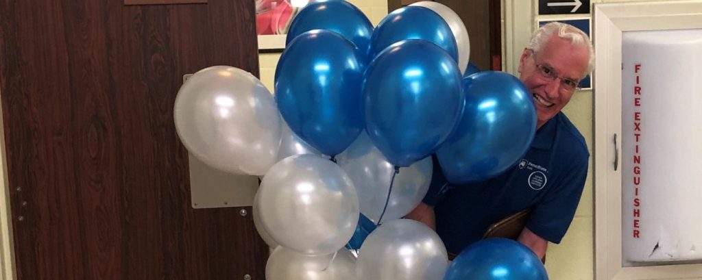 Volunteer holding baloons